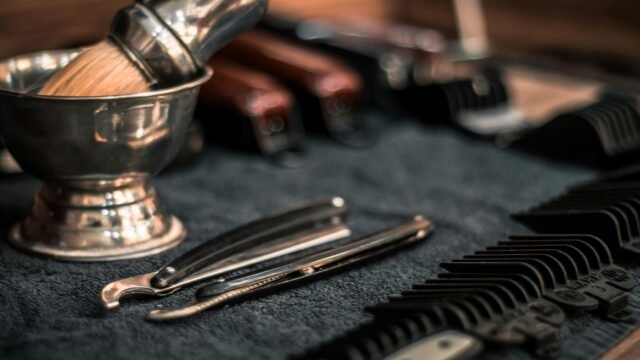 Close-up of neatly arranged barber tools, including razors and combs, highlighting precision.