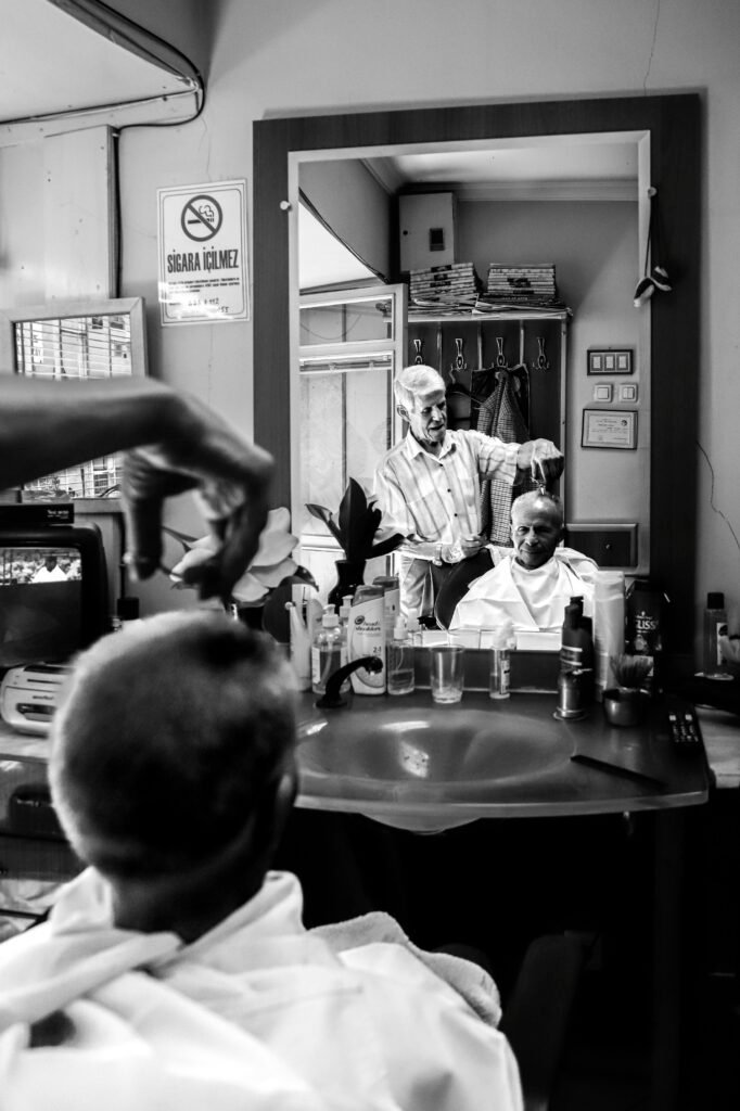 A classic barbershop setting captured in black and white in Bursa, Türkiye.